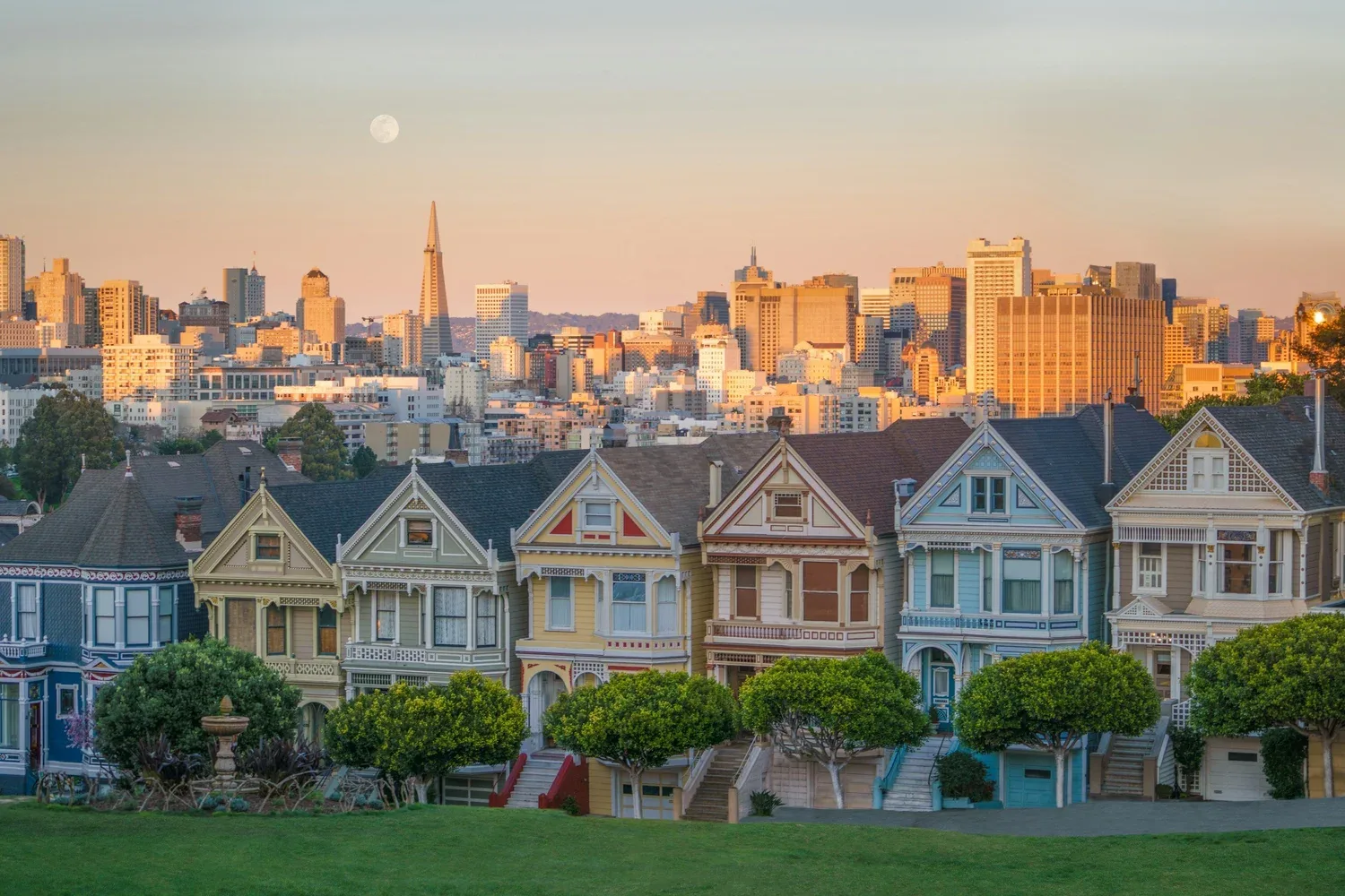 San Francisco's Painted Ladies and skyline in warm evening light.